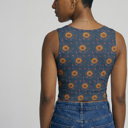 Person wearing a sleeveless top with sunflower pattern and blue jeans on a plain background