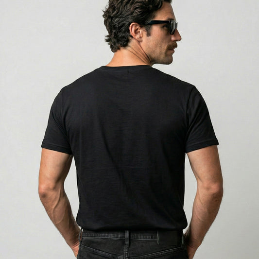 Man wearing a black t-shirt against a plain background