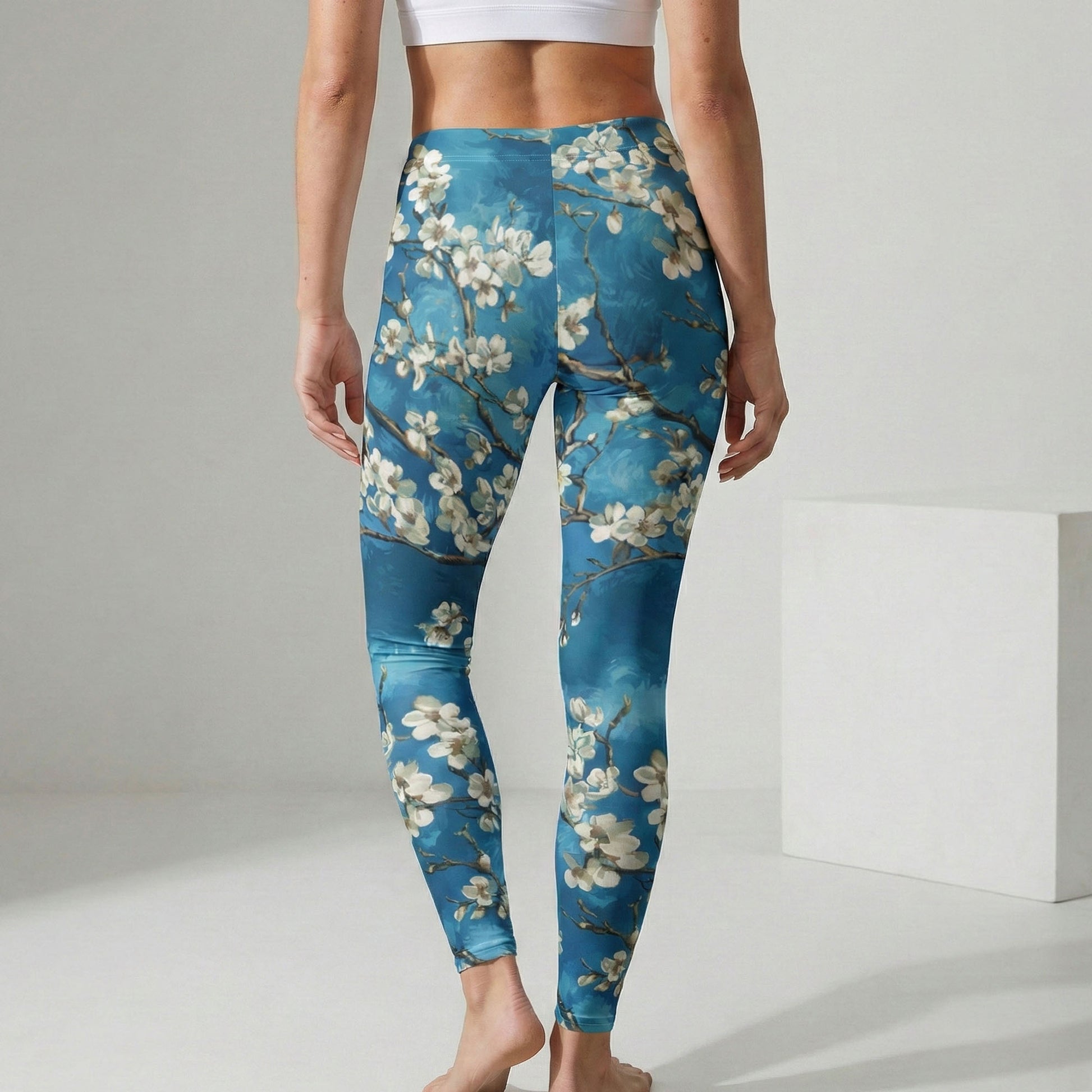 Person wearing blue floral leggings on a plain background
