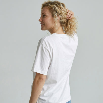 Woman wearing a plain white t-shirt against a light gray background