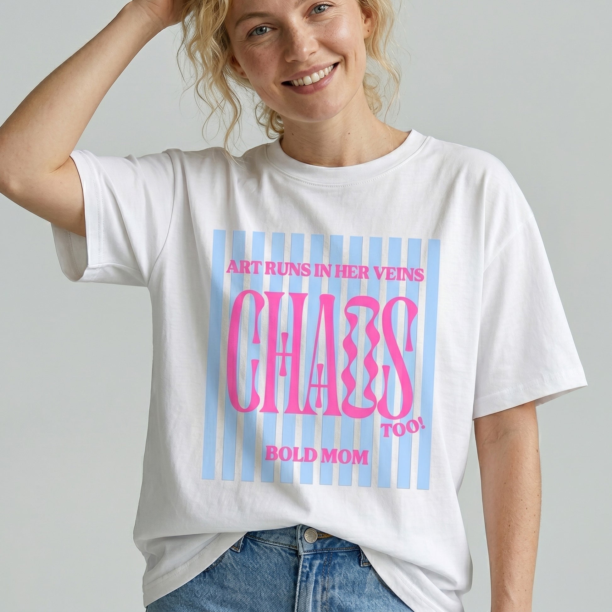 Person wearing a white t-shirt with colorful text design on a plain background