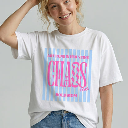 Person wearing a white t-shirt with colorful text design on a plain background