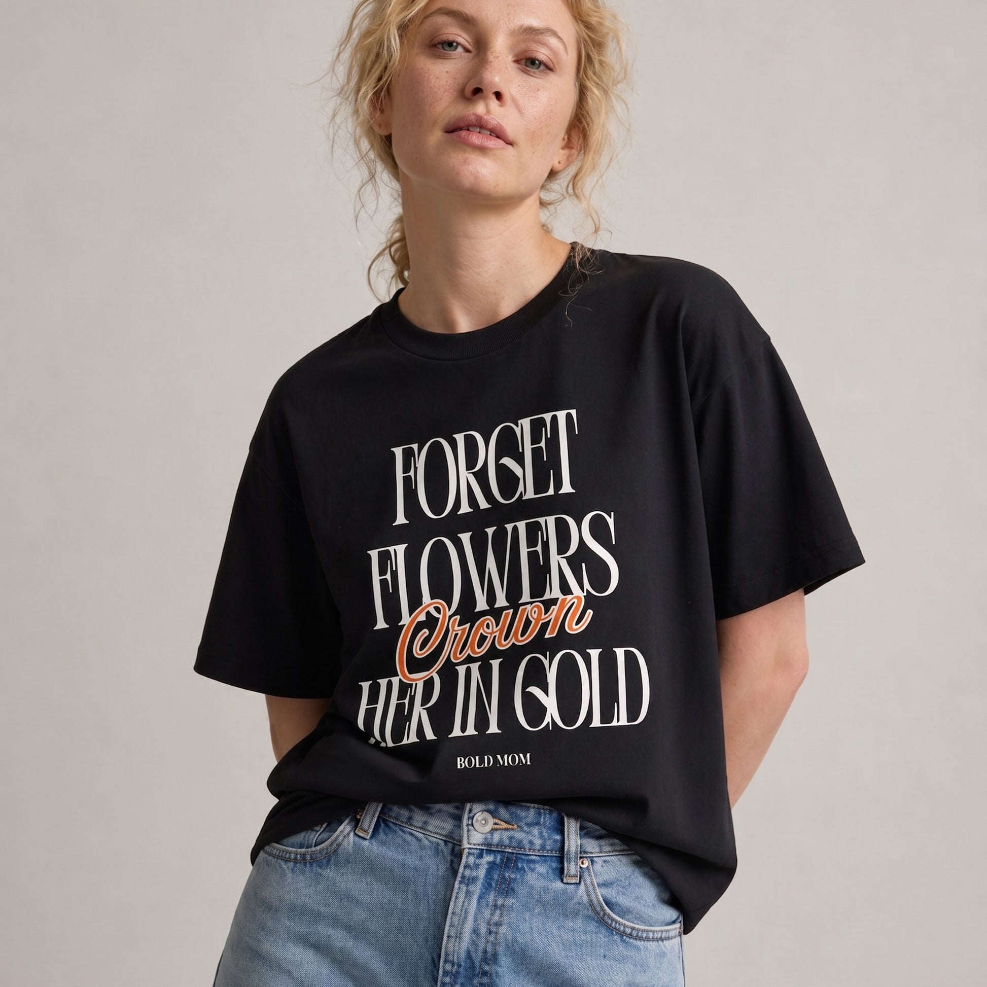Person wearing a black t-shirt with text on a plain background
