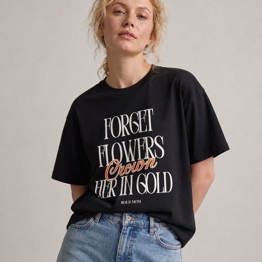 Person wearing a black t-shirt with text on a plain background