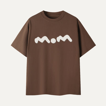 Brown t-shirt with 'mom' printed in white on a light gray background