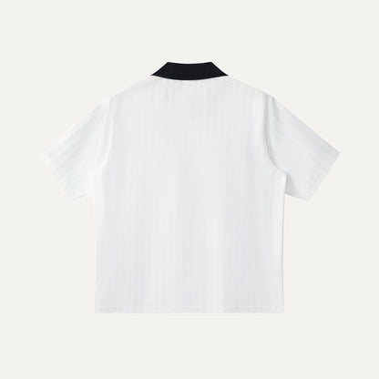 White t-shirt with black collar on a white background