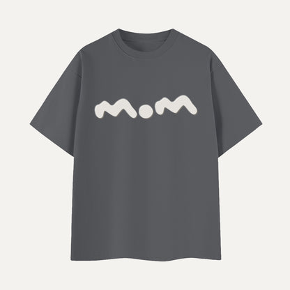 Gray t-shirt with 'mom' printed on it against a light gray background