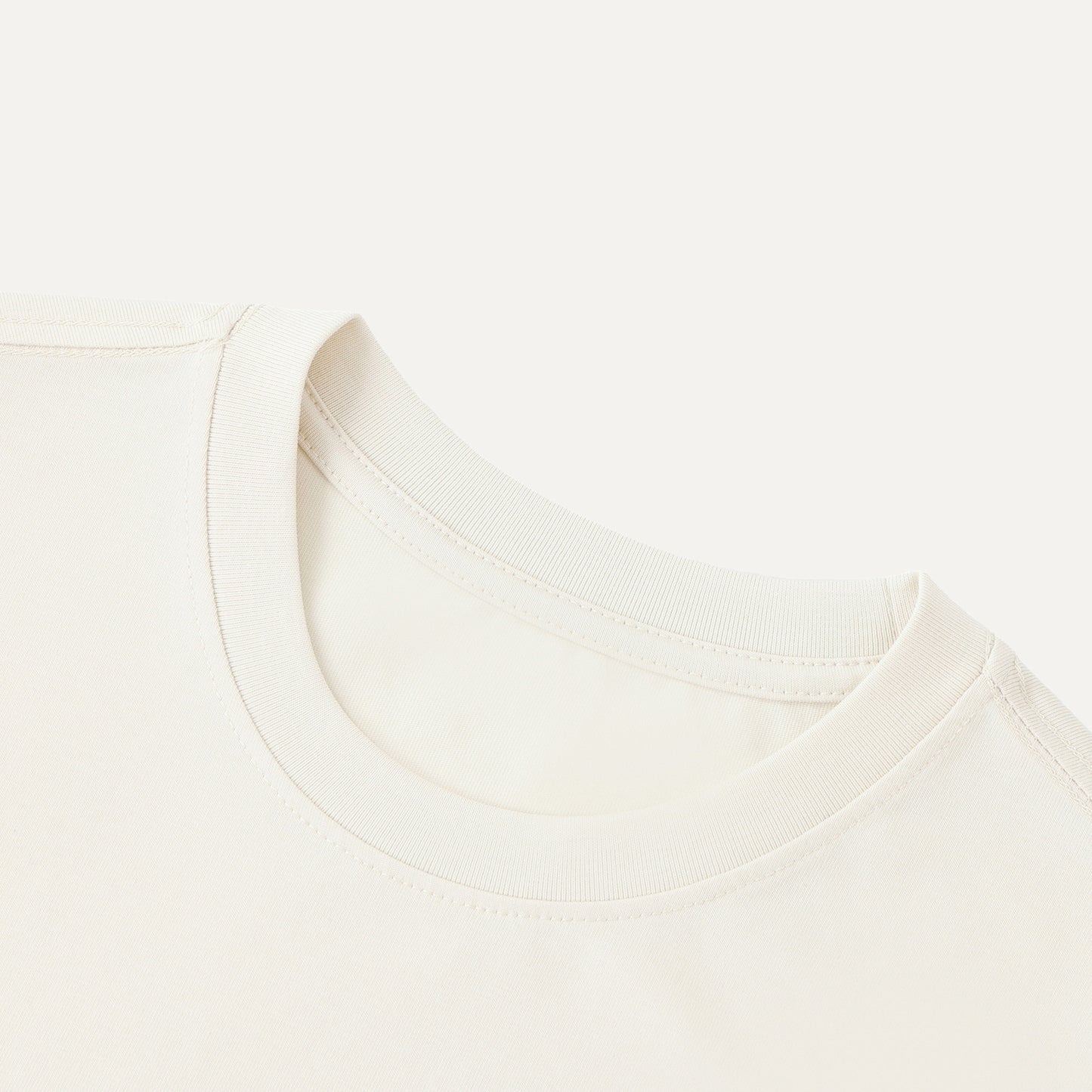 Close-up of a white shirt with a collar on a light beige background