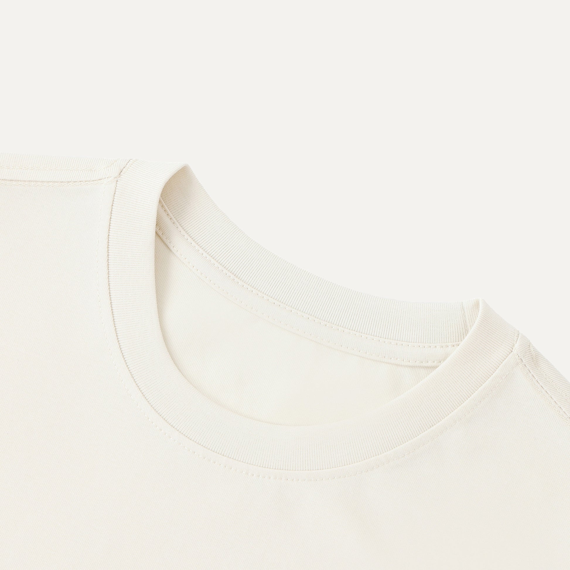 Close-up of a white shirt with a collar on a light beige background