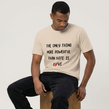 Man wearing a t-shirt with a motivational message sitting on a stool against a plain background