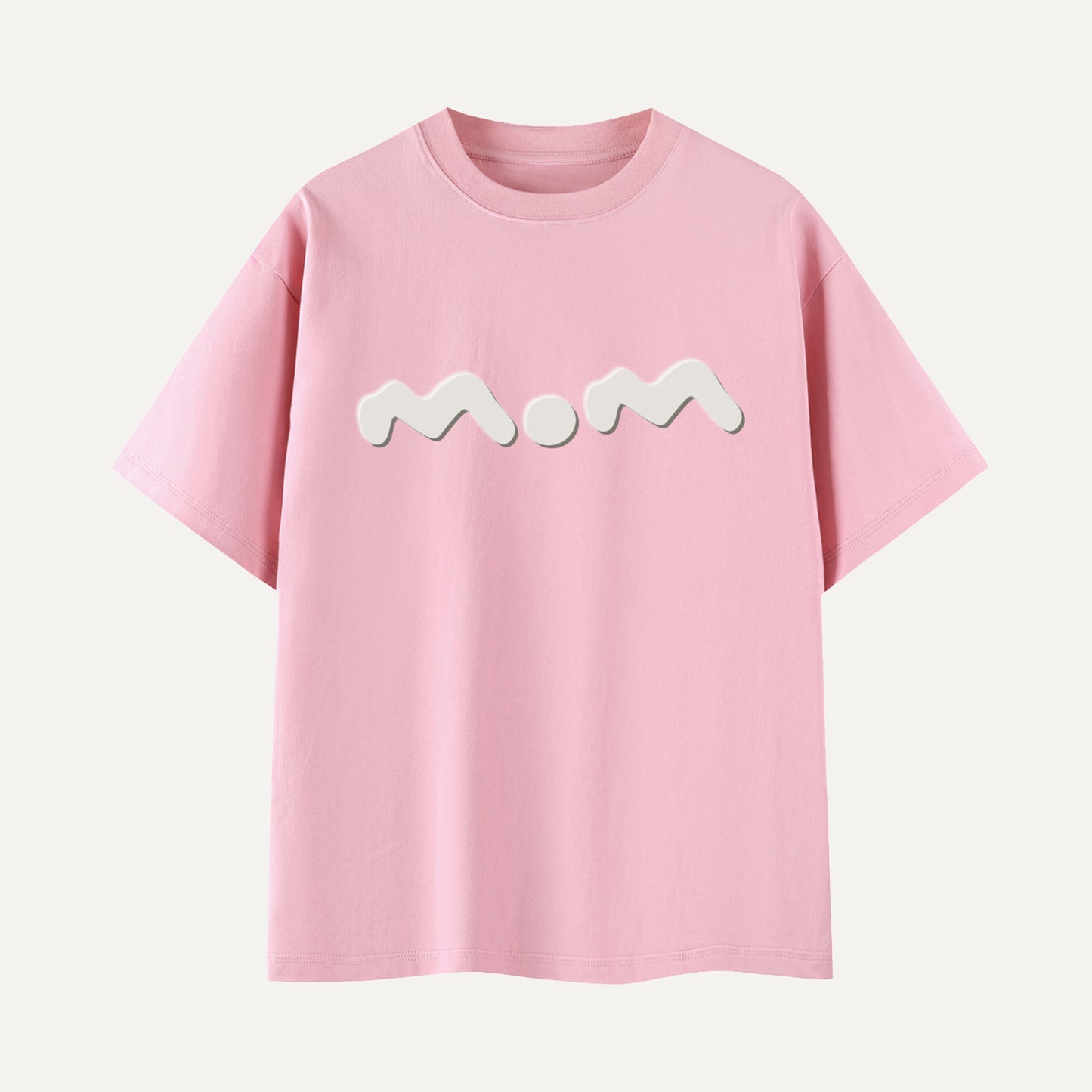 Pink t-shirt with 'Mom' printed on it against a white background