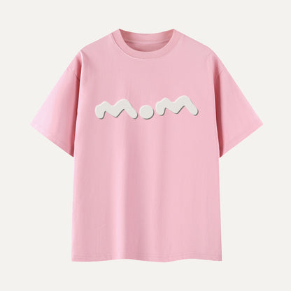 Pink t-shirt with 'Mom' printed on it against a white background