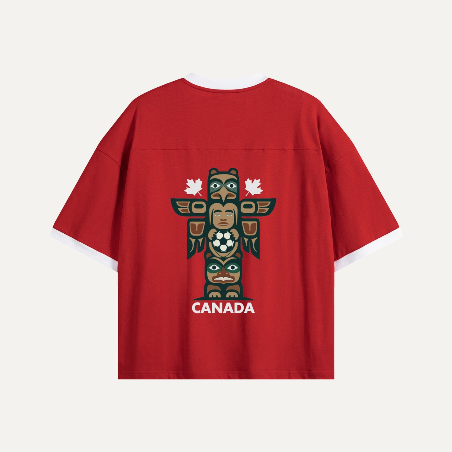 Flat lay of the back of a red Gallery of Nations jersey featuring a detailed totem pole graphic holding a soccer ball, flanked by two white maple leaves.