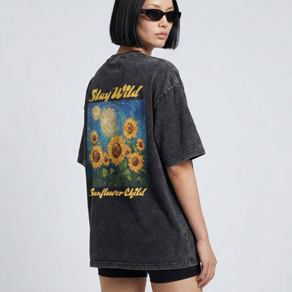 Person wearing a black t-shirt with sunflower design and 'Stay Wild Sunflower Child' text on a plain background