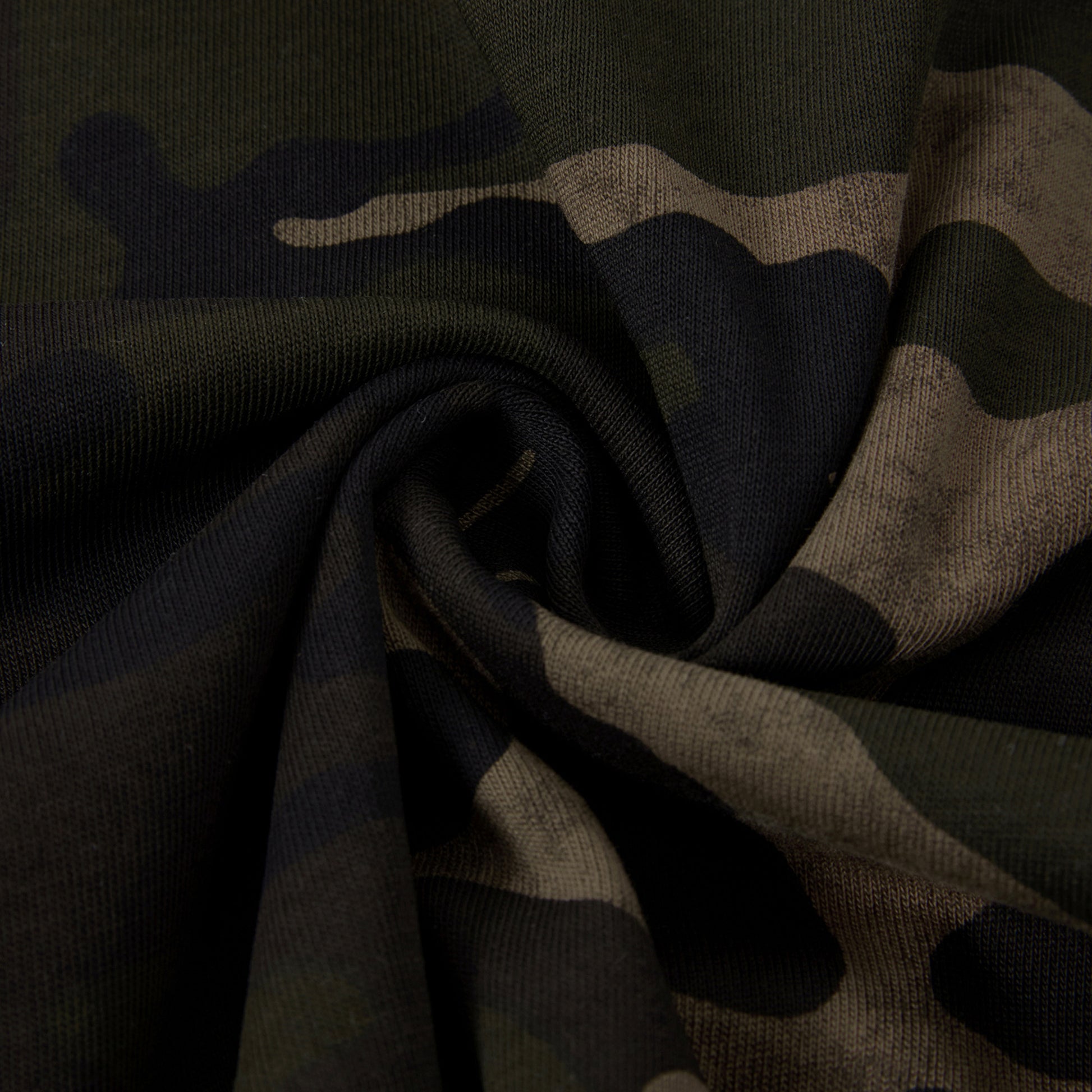 Close-up of camouflage fabric with a focus on texture and pattern.
