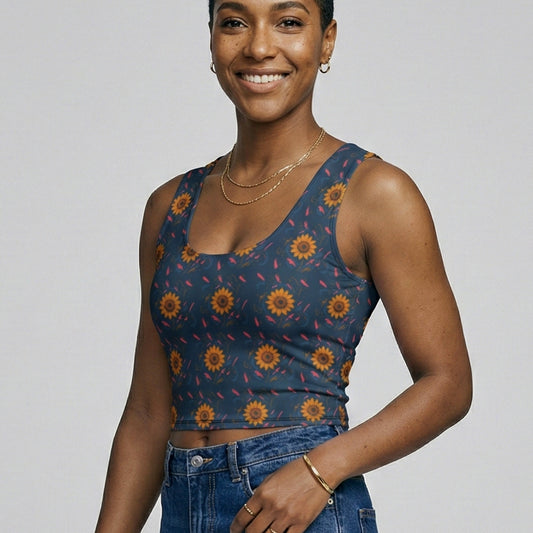 Woman wearing a patterned top and jeans on a plain background