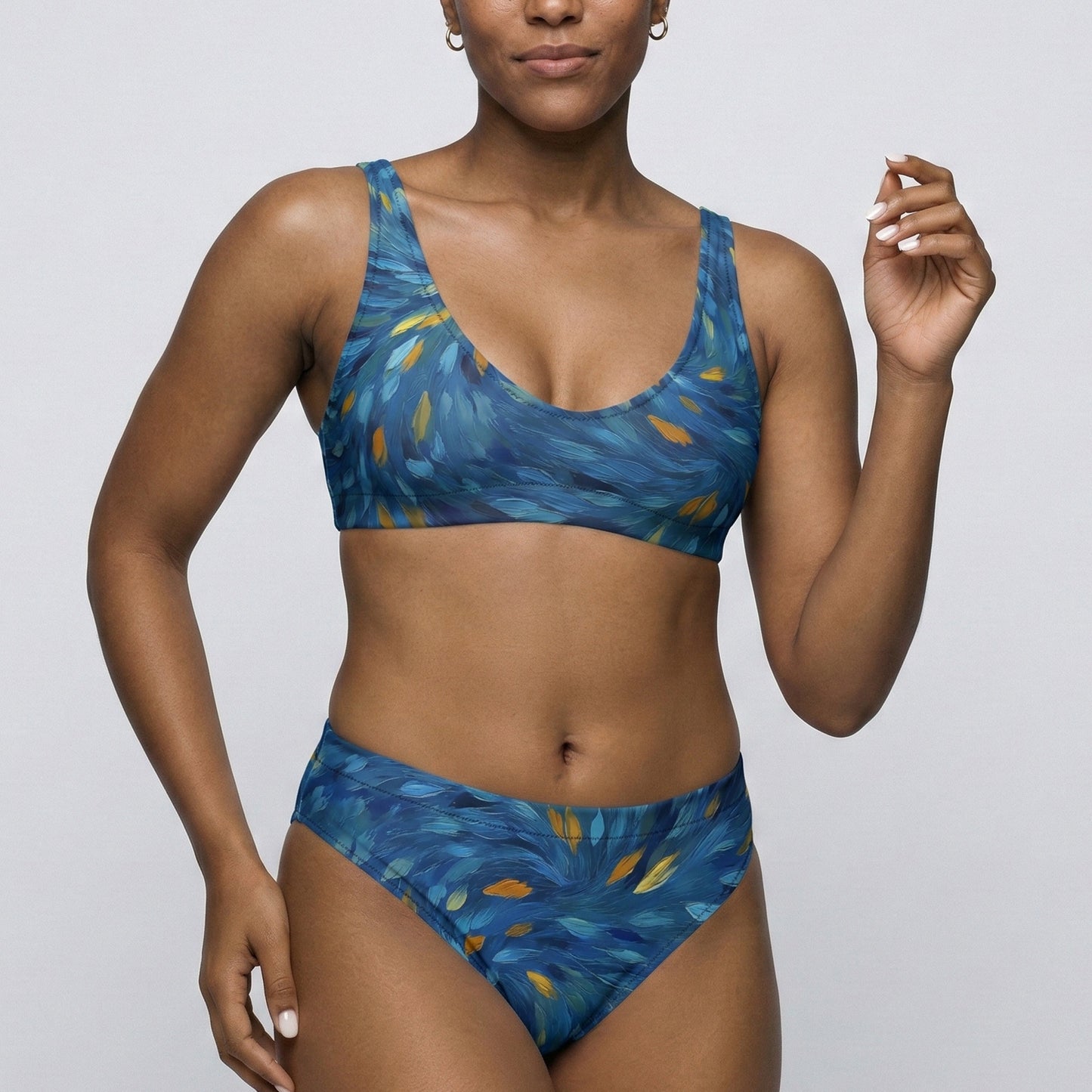 Woman wearing a blue patterned bikini against a plain background