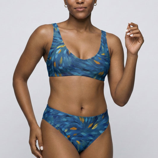Woman wearing a blue patterned bikini against a plain background