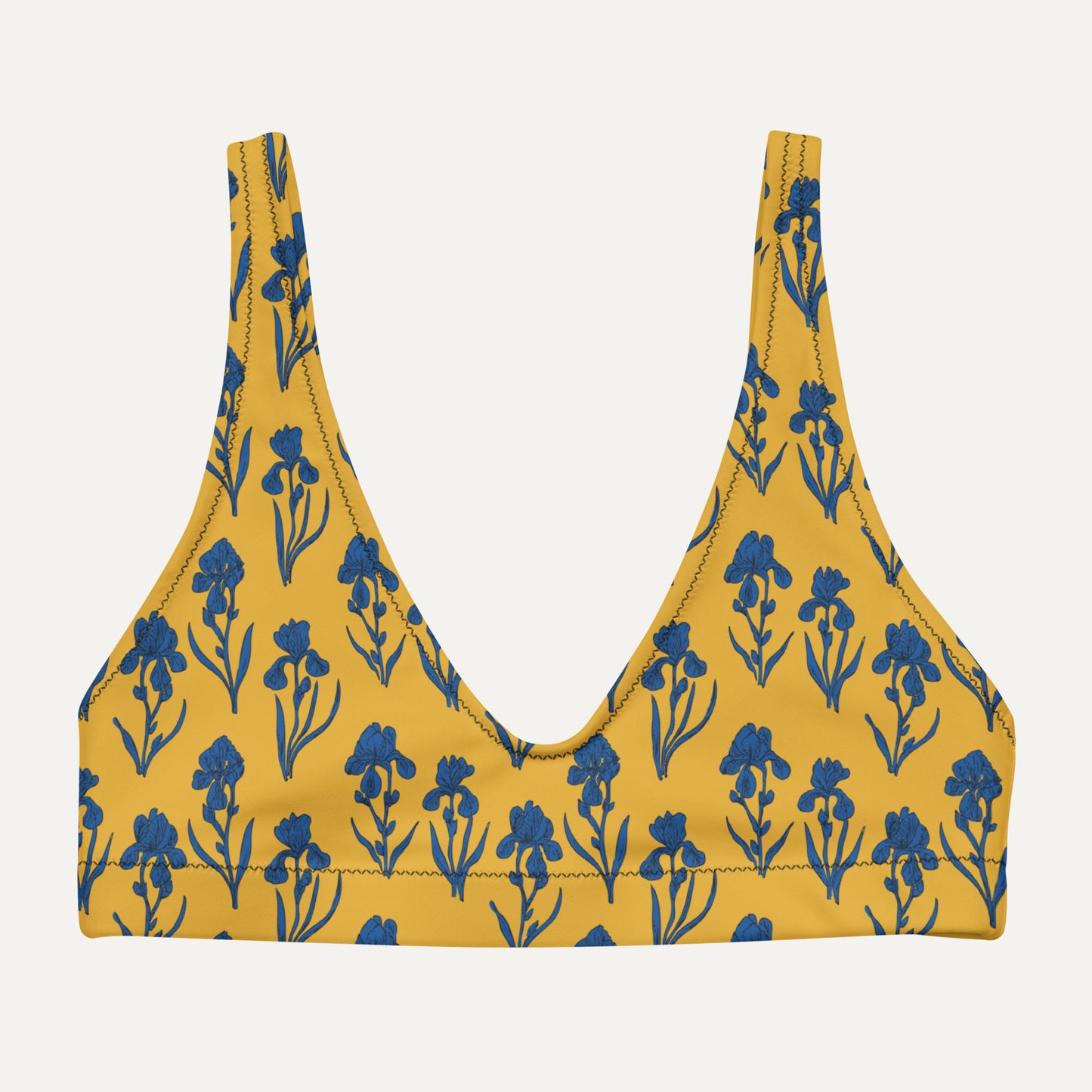 Yellow bikini top with blue floral pattern on a light gray background