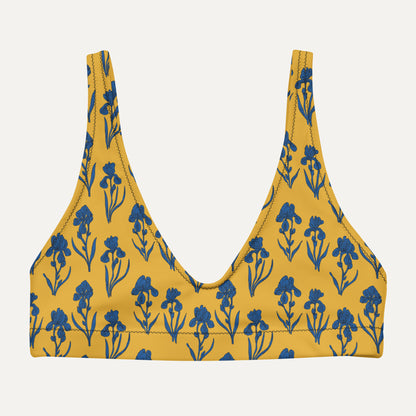 Yellow bikini top with blue floral pattern on a light gray background