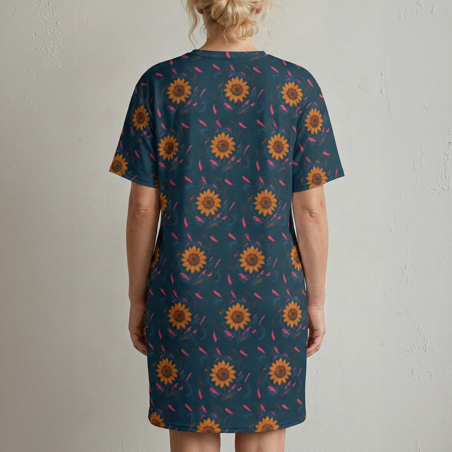 Person wearing a blue dress with sunflower pattern against a plain background