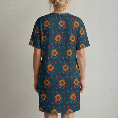 Person wearing a blue dress with sunflower pattern against a plain background