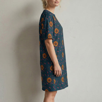 Woman wearing a patterned dress against a plain background