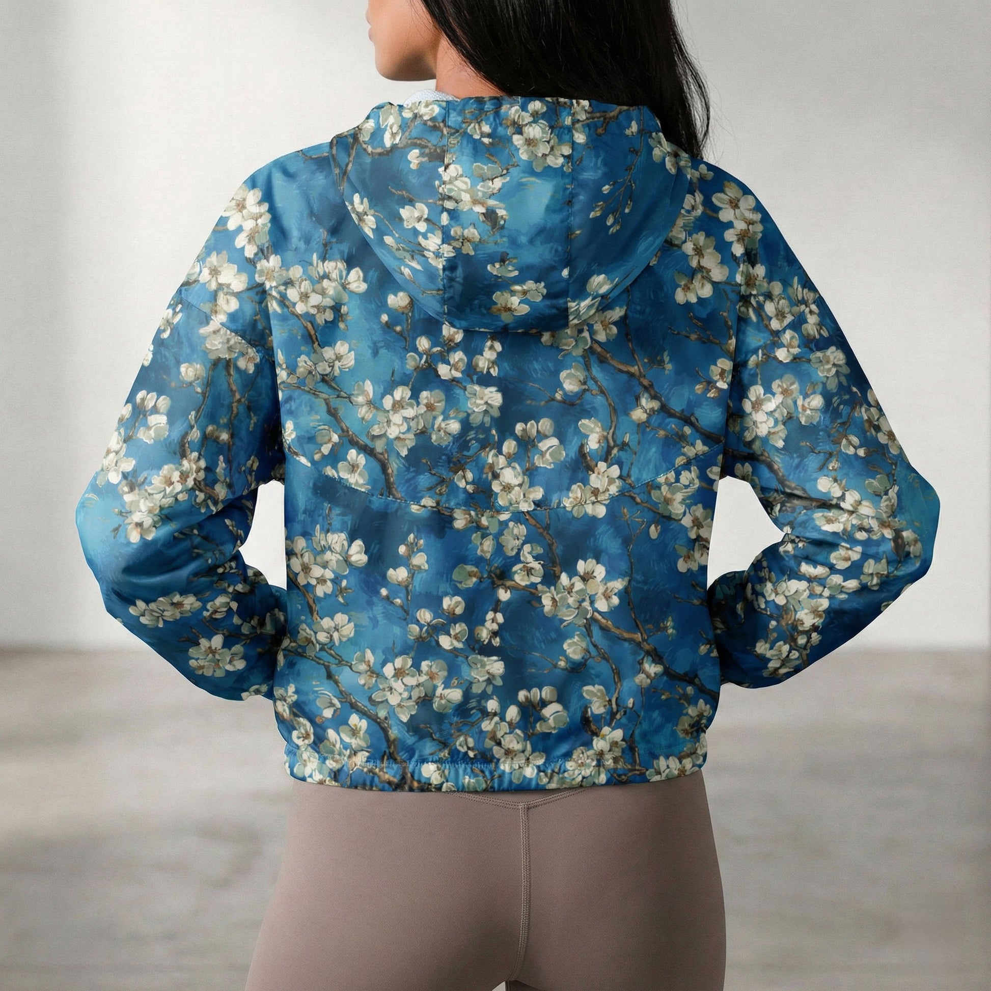 Person wearing a blue floral-patterned jacket with a blurred background