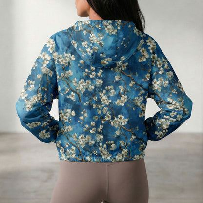 Person wearing a blue floral-patterned jacket with a blurred background
