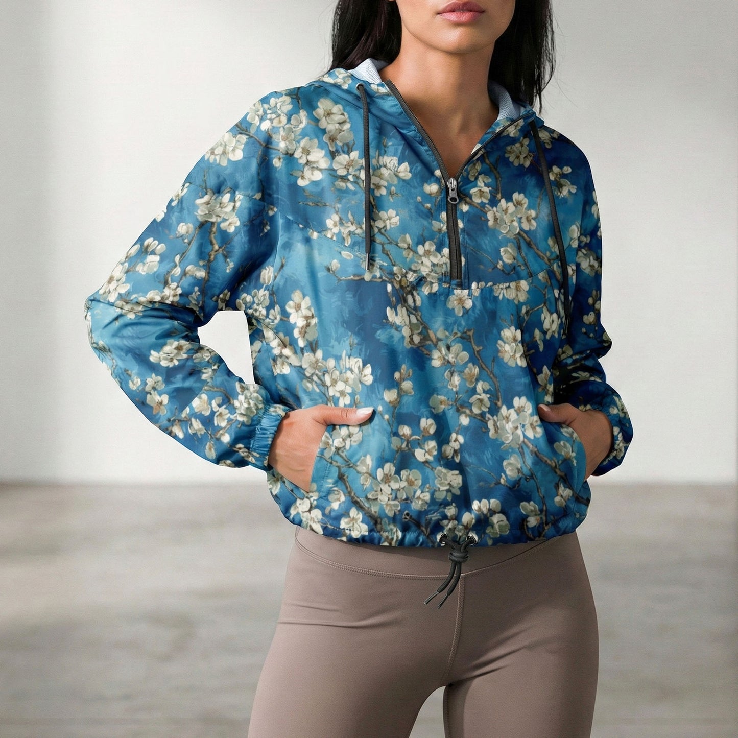 Woman wearing a blue floral-patterned jacket with a neutral background