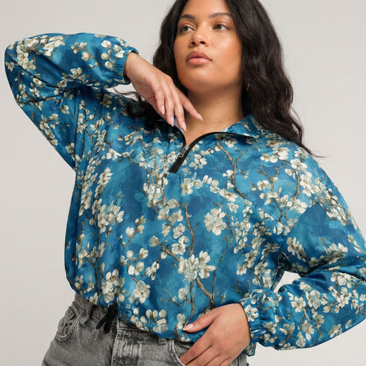Woman wearing a blue floral jacket on a plain background