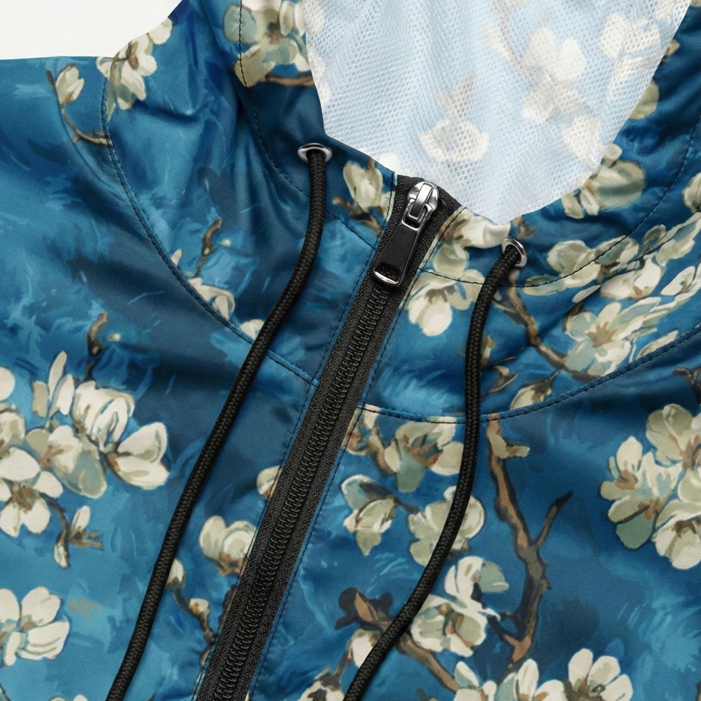 Close-up of a blue floral-patterned jacket with a zipper.