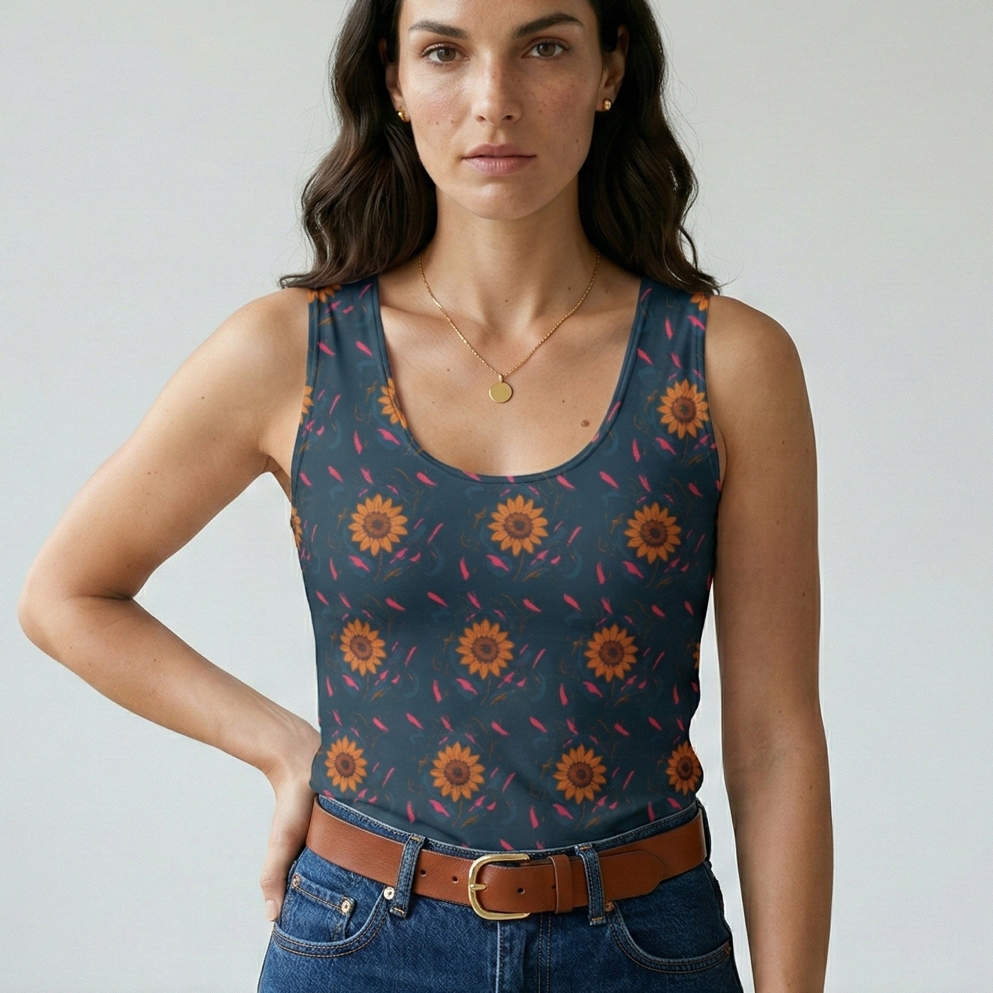 Woman wearing a tank top with sunflower pattern against a plain background