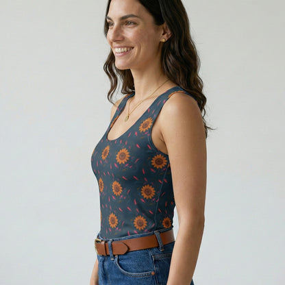 Woman wearing a patterned tank top and jeans against a plain background