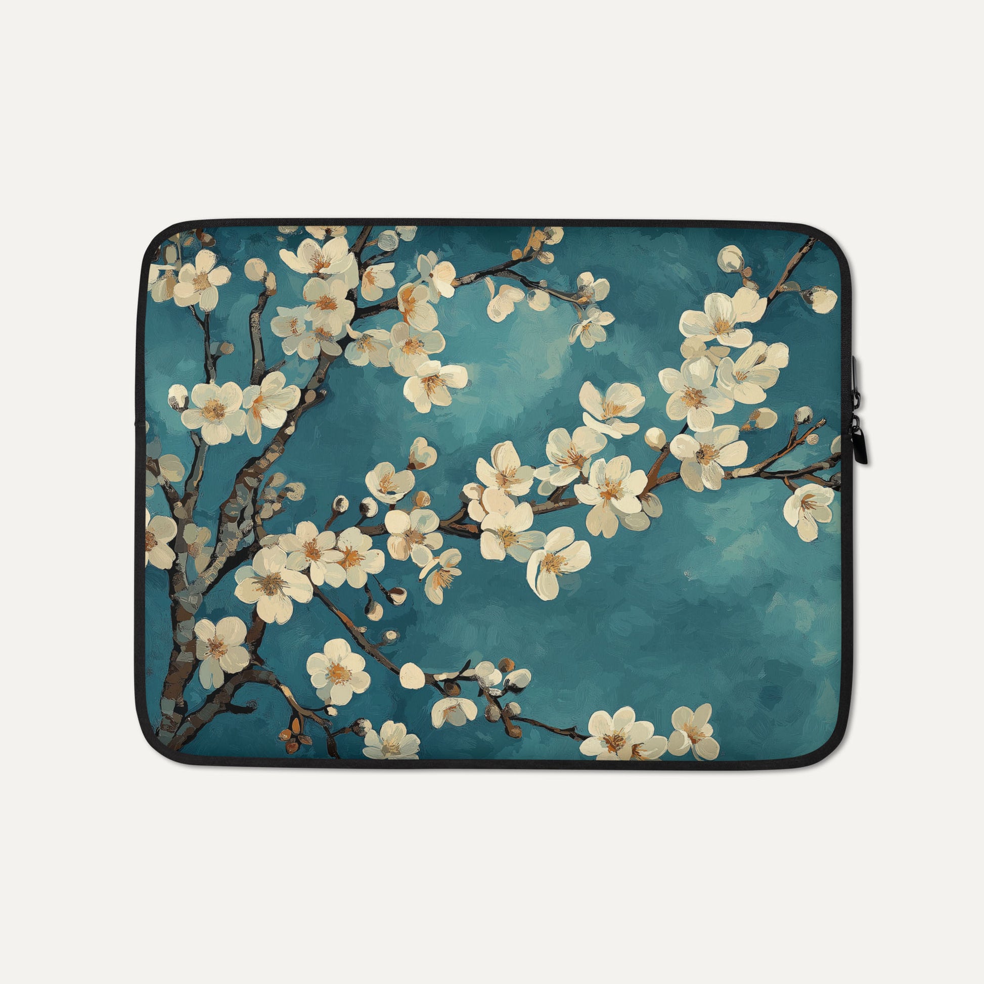 Laptop sleeve with cherry blossom design on a blue background