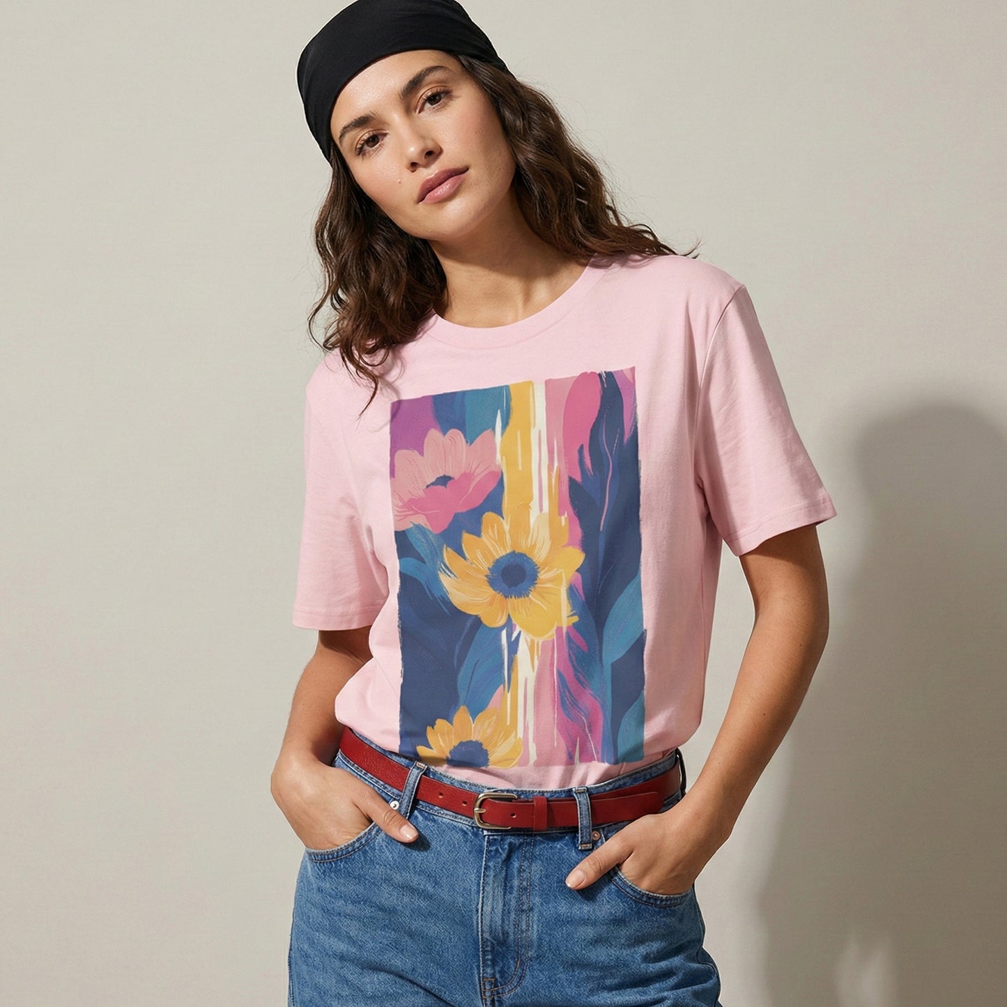 Person wearing a pink t-shirt with a colorful floral design, standing against a plain background.