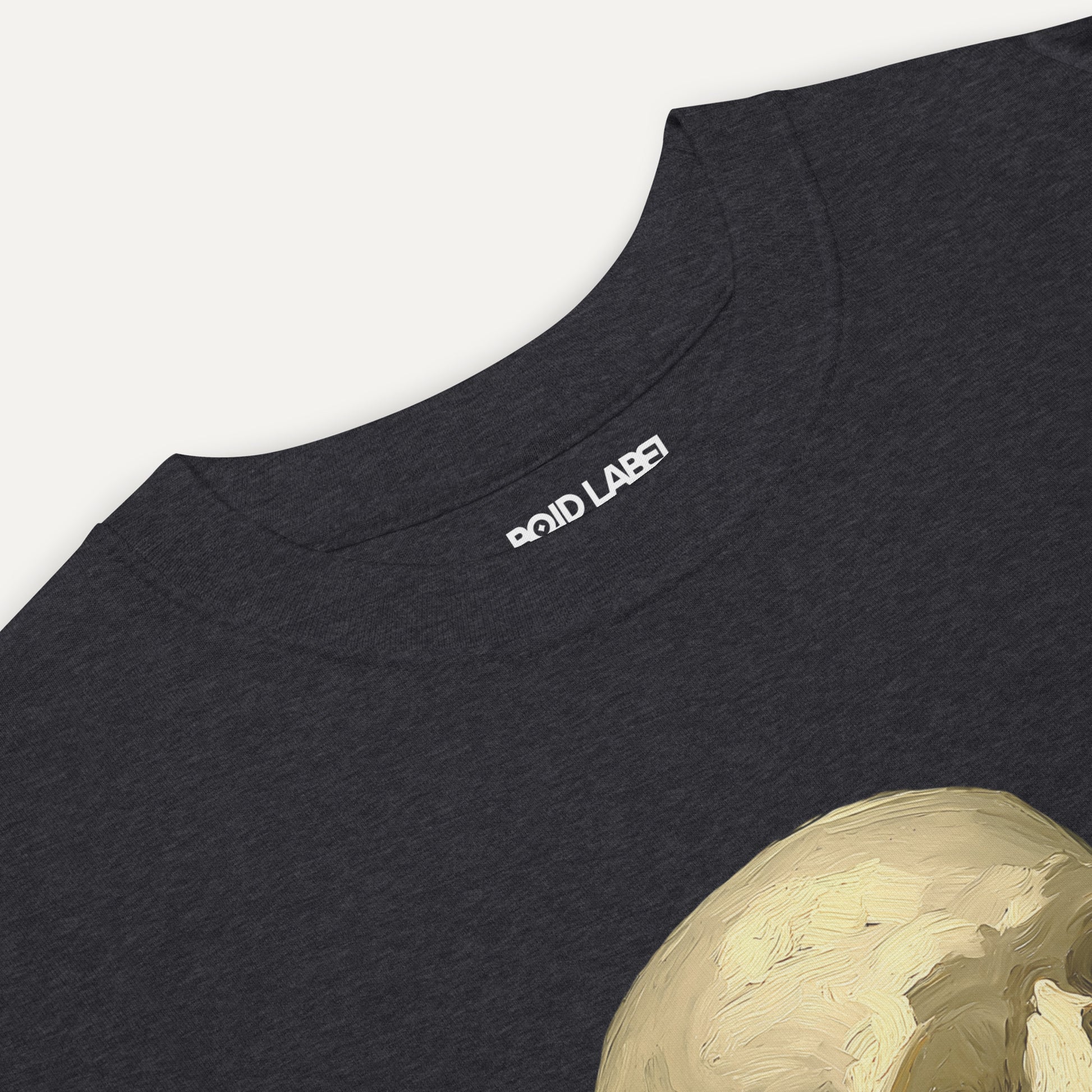 Black t-shirt with a gold graphic design on a white background