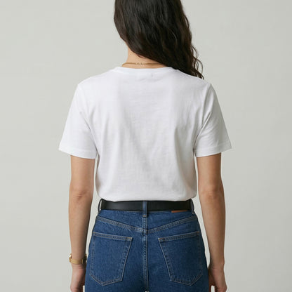 Person wearing a white t-shirt and blue jeans from behind on a plain background